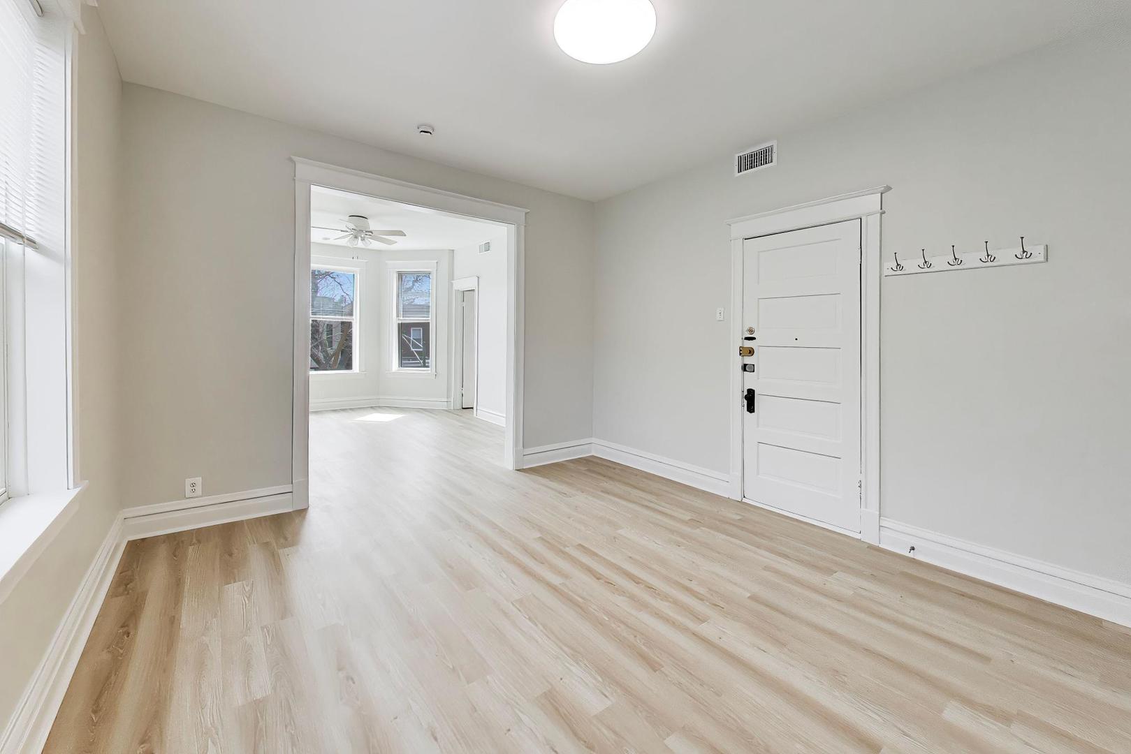 1646 West Byron Street, Unit 2F Chicago, IL 60613 - Photo 10 of 27 wooden floor in an empty room