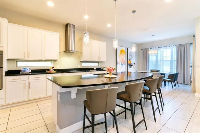a kitchen with a sink and chairs