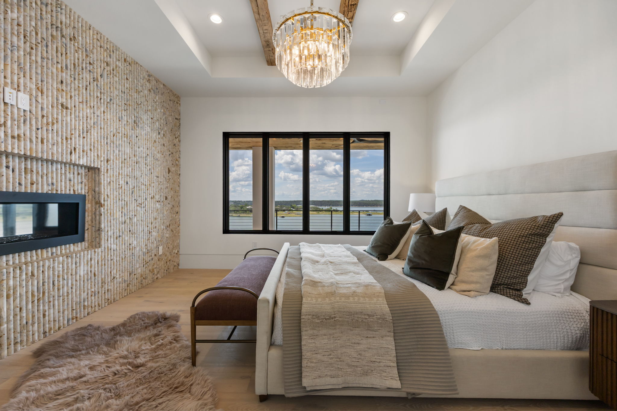 1496 Buffalo Gap Road Lakeway, TX 78734 - Photo 20 of 37 Unwind in this serene bedroom, featuring a captivating fireplace and an inspiring lake view.