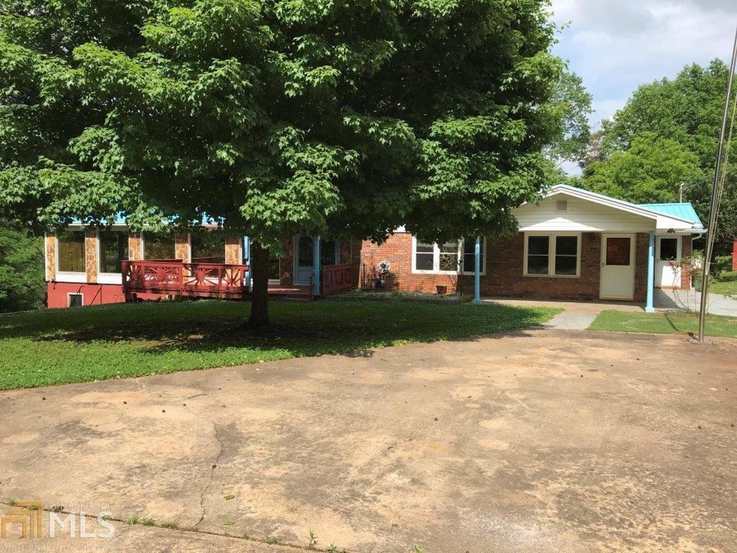 1886 Moccasin Gap Road Lula, GA 30554 - Photo 1 of 1 a front view of a house with a yard and trees