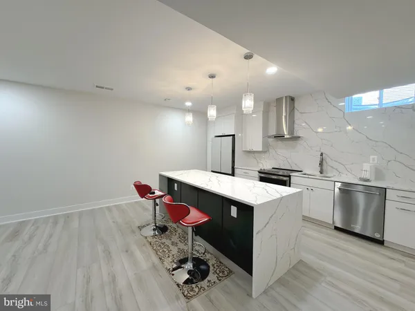 a kitchen that has a sink and a stove in it
