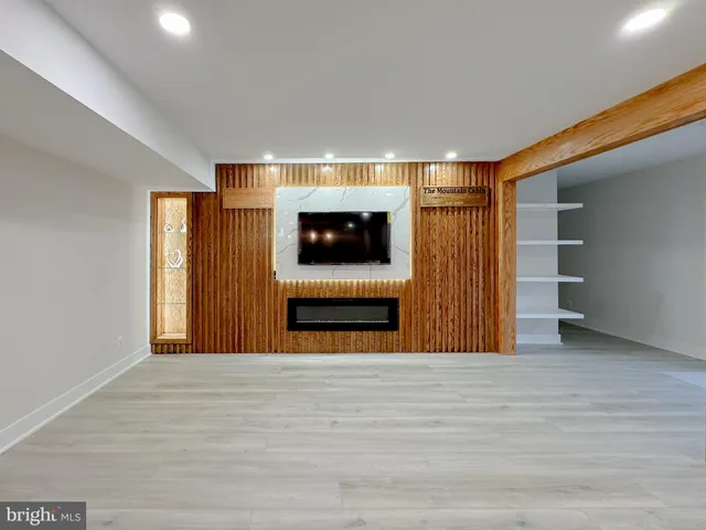 a view of an empty room with a fireplace