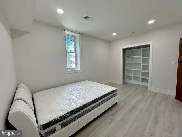 a bedroom with a bed and a window