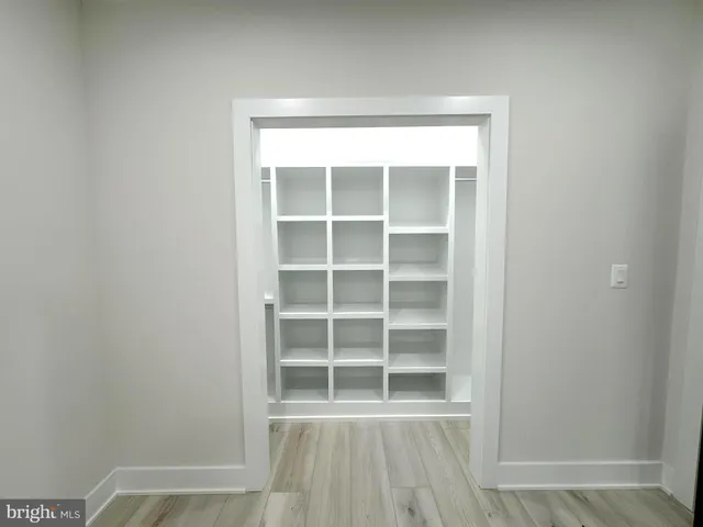 a view of wooden floor and windows in a room