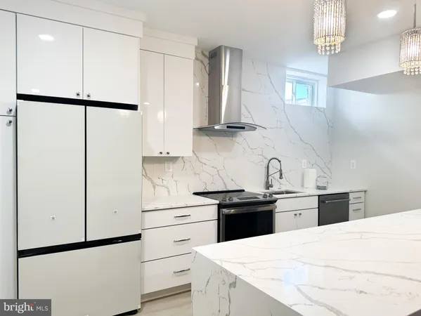 a kitchen with kitchen island white cabinets and refrigerator