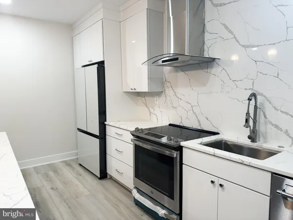 a kitchen with granite countertop a sink and a stove top oven