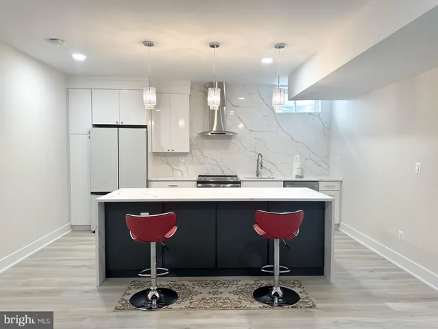 a table with chairs in it and kitchen view