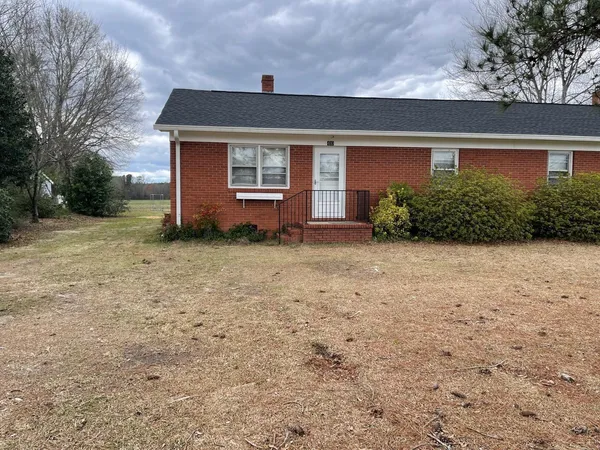 a front view of a house with a yard