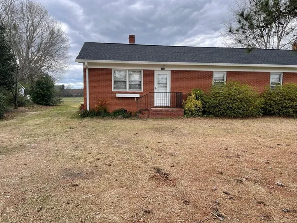 a front view of a house with a yard