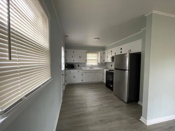 a kitchen with stainless steel appliances a refrigerator and a more window