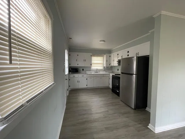 a kitchen with stainless steel appliances a refrigerator and a more window