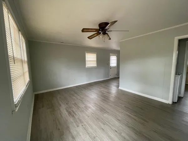 wooden floor in an empty room with a window