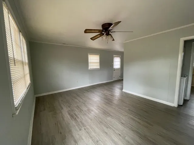 wooden floor in an empty room with a window