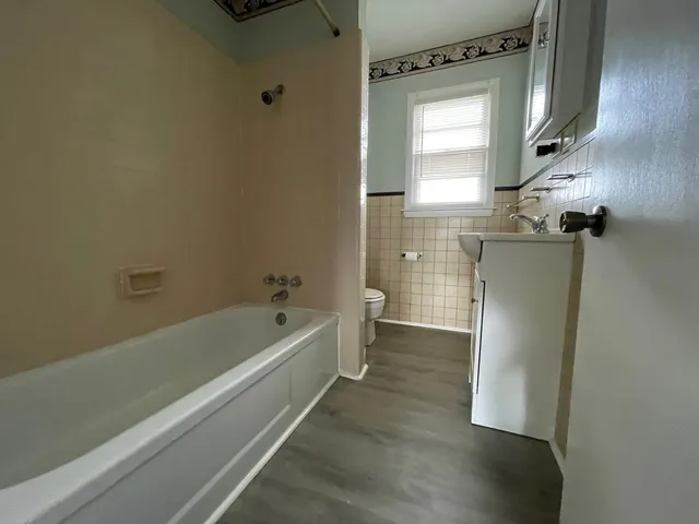 a bathroom with a bathtub a toilet and a shower