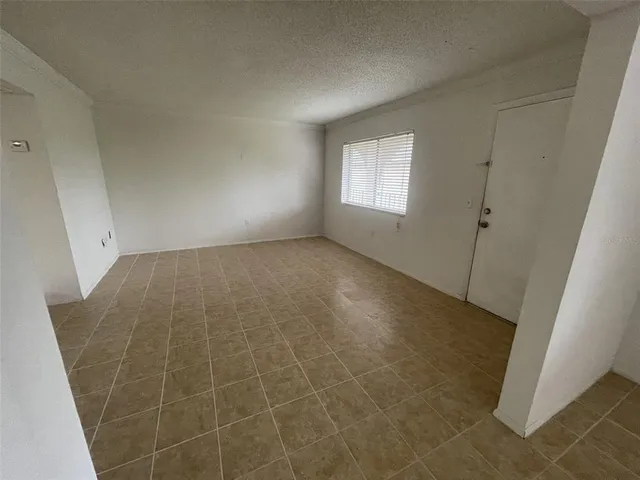 a view of an empty room and a window