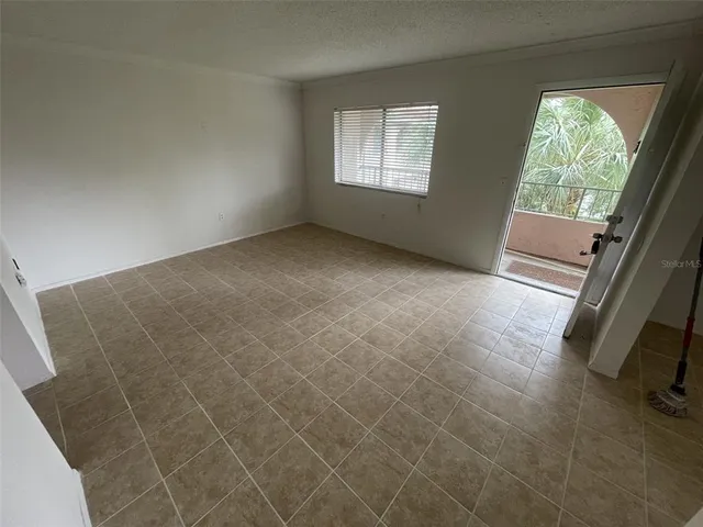 a view of an empty room and a window