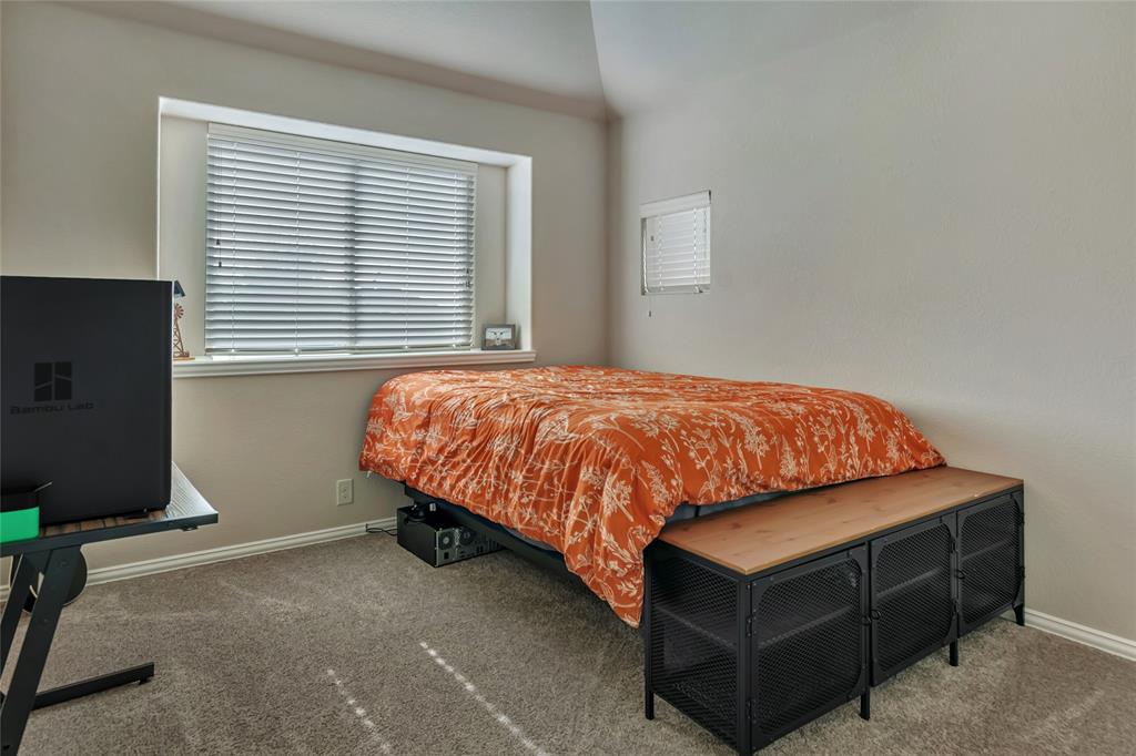 629 Fox View Drive Fort Worth, TX 76131 - Photo 30 of 38 a bedroom with a bed and a flat tv screen on a dresser