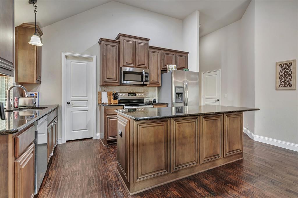629 Fox View Drive Fort Worth, TX 76131 - Photo 10 of 38 a kitchen with white cabinets and stainless steel appliances