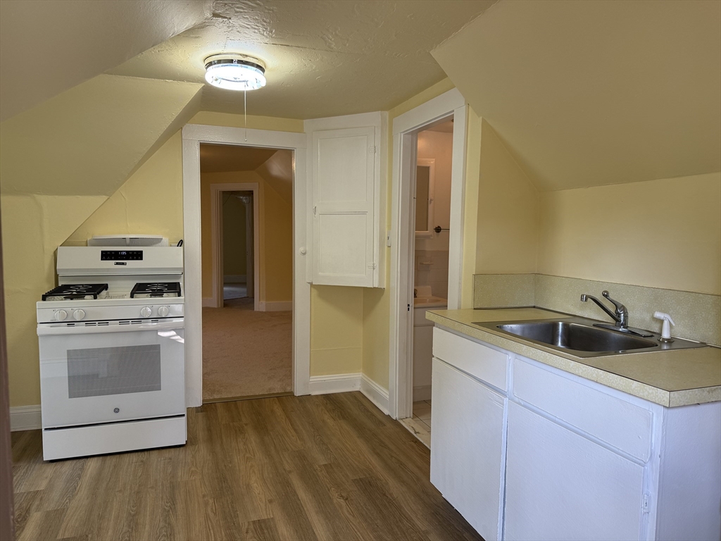5 Brown, Unit 3 Boston, MA 02131 - Photo 3 of 7 a kitchen with a sink stove and refrigerator