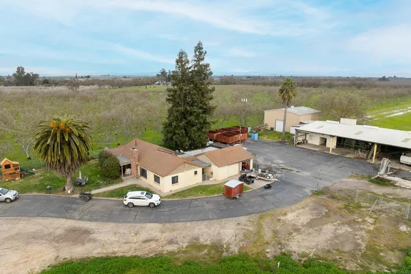 an aerial view of a house with outdoor space patio and lake view