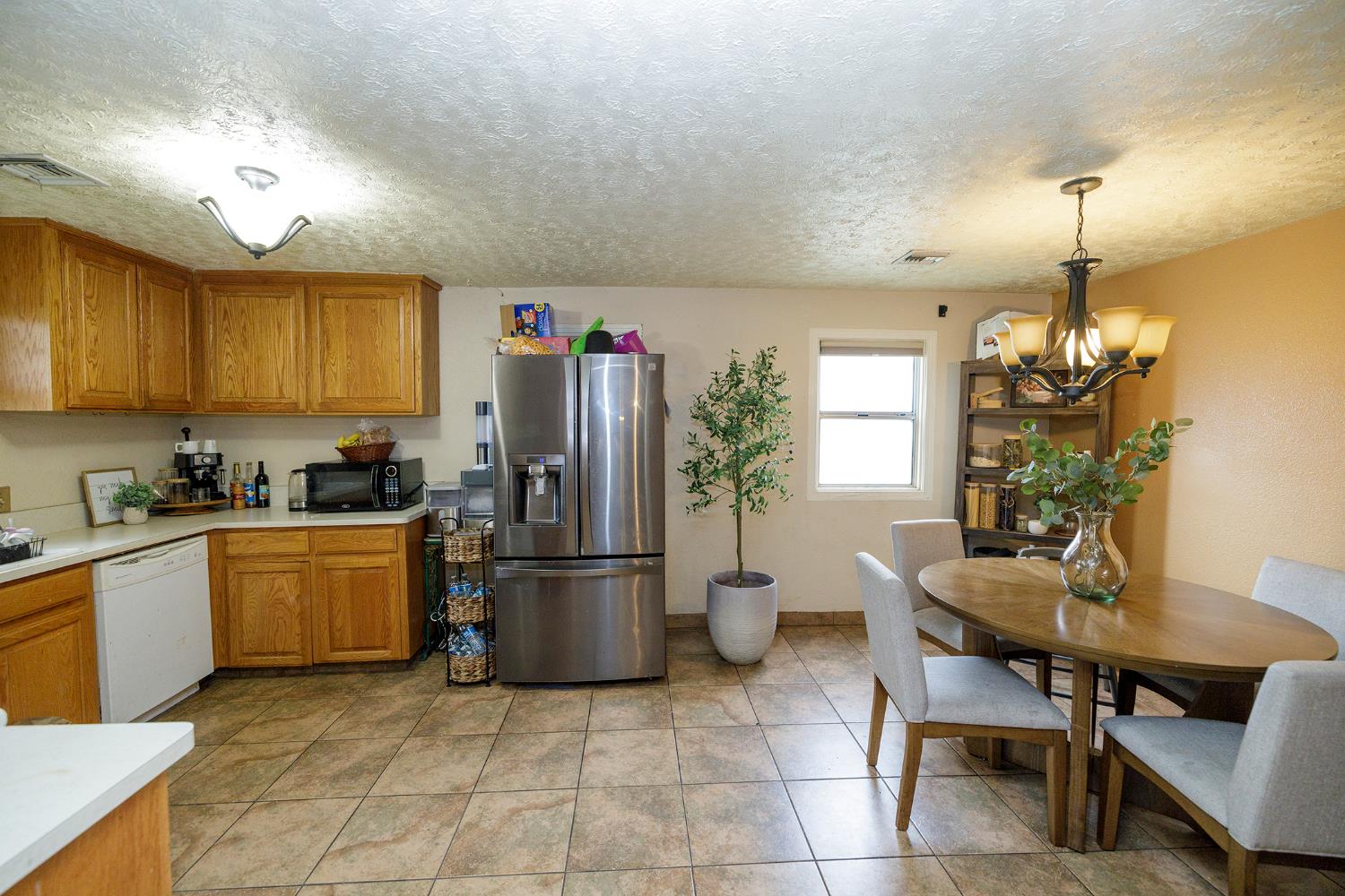 618 Wellsford Road Modesto, CA 95357 - Photo 13 of 26 a kitchen with refrigerator and chairs