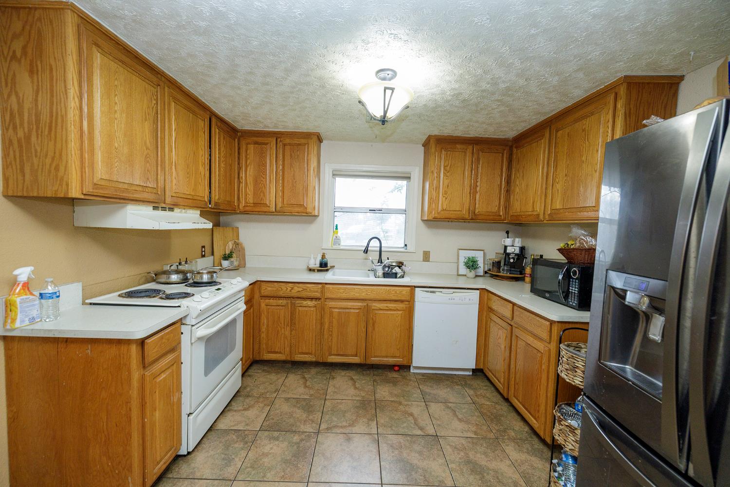 618 Wellsford Road Modesto, CA 95357 - Photo 14 of 26 a kitchen with stainless steel appliances granite countertop a stove refrigerator sink and cabinets