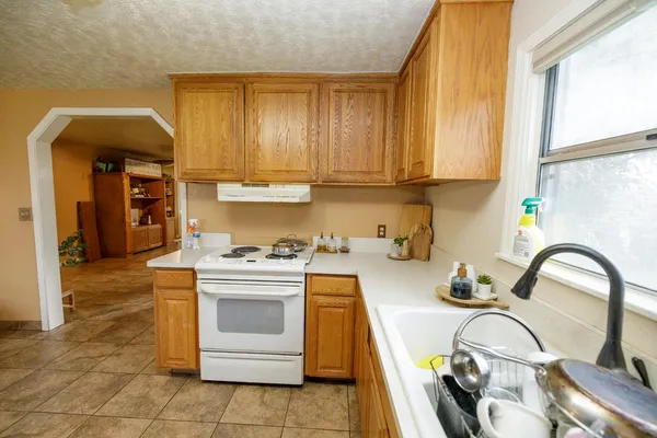 a kitchen with a stove a sink and a refrigerator