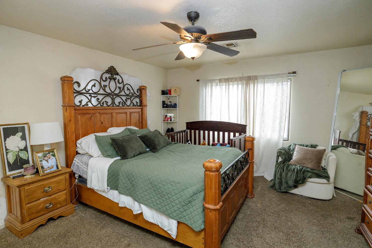 618 Wellsford Road Modesto, CA 95357 - Photo 18 of 26 a bedroom with a bed and a chandelier