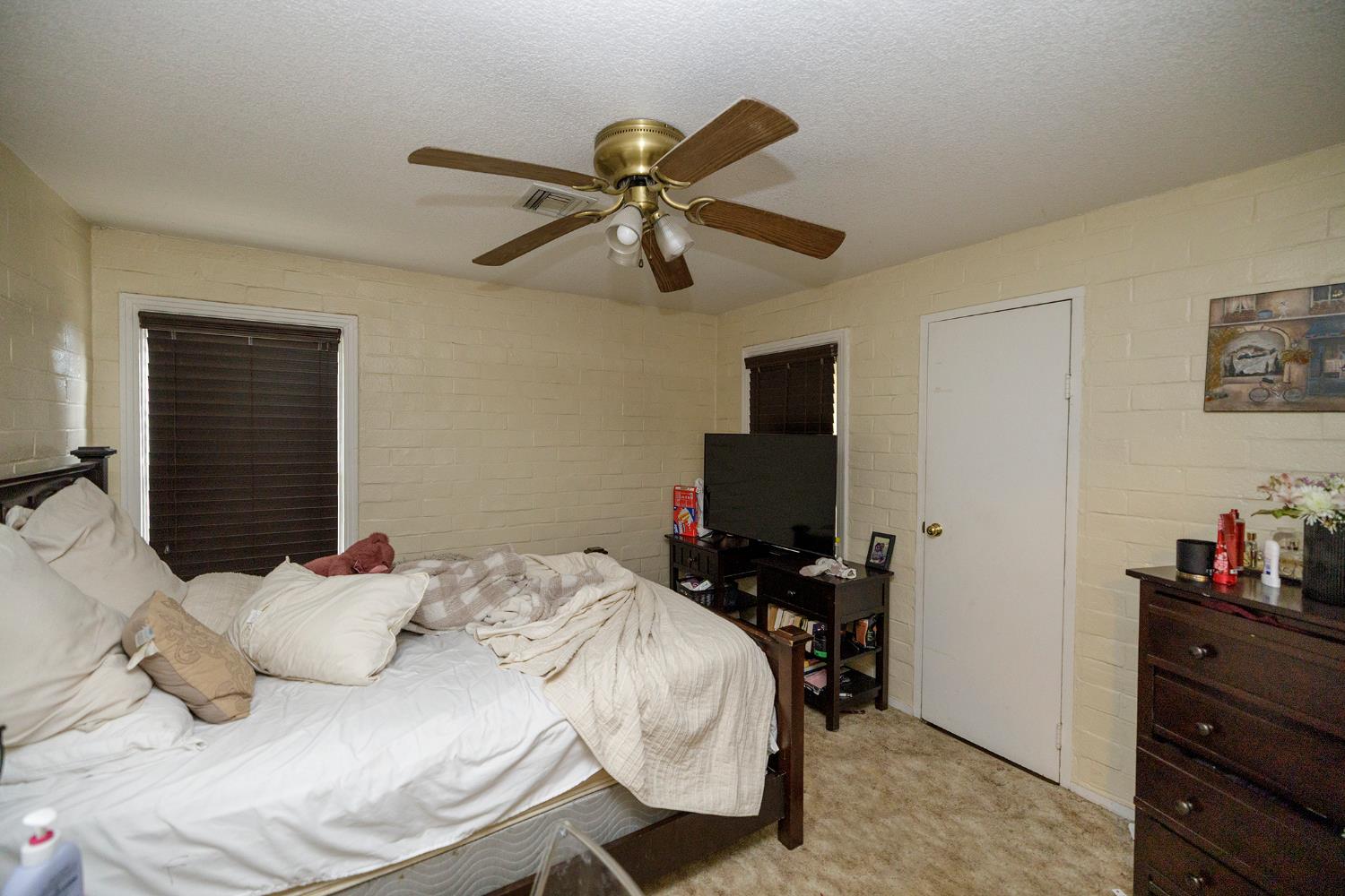 618 Wellsford Road Modesto, CA 95357 - Photo 22 of 26 a bedroom with a bed and a flat screen tv