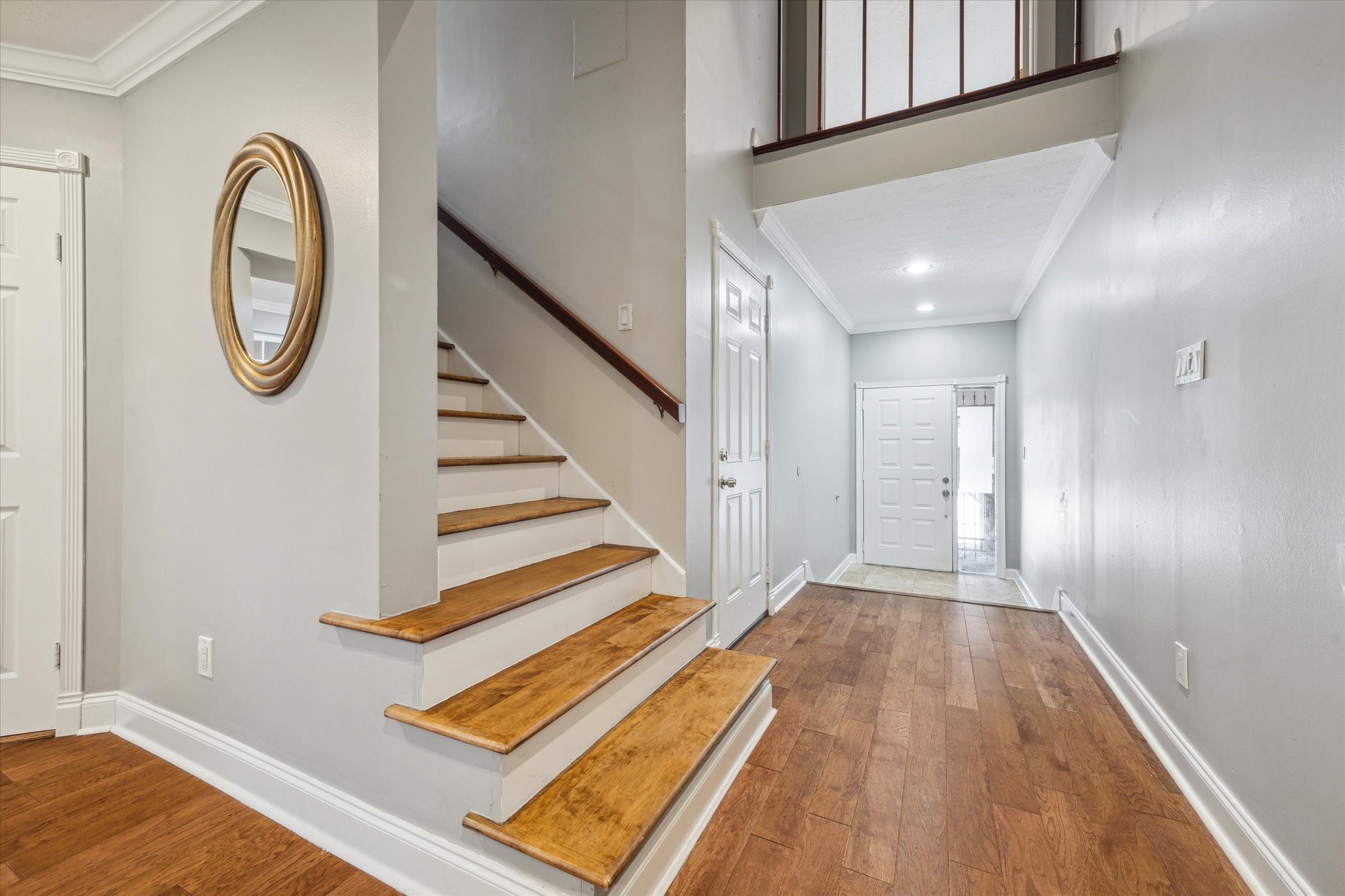 2107 Morgan Street Houston, TX 77006 - Photo 2 of 13 Wide formal entry welcomes you home with soaring ceilings & rich hardwood floors throughout. Staircase leading to second floor bedrooms, work space and washer/dryer area.