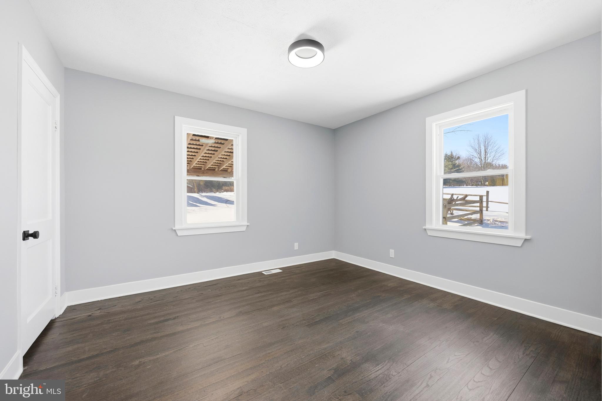 3170 Sykesville Road Westminster, MD 21157 - Photo 23 of 37 a view of an empty room with wooden floor and a window