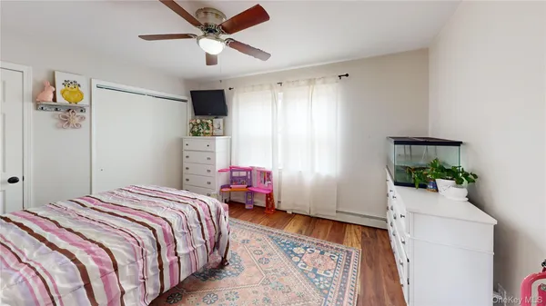 a bedroom with a bed and a chandelier fan