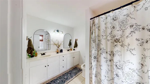 a bathroom with a double vanity sink and mirror