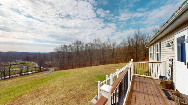 a view of a balcony with wooden floor and outdoor space