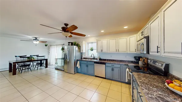 a kitchen with lots of counter top space and stainless steel appliances