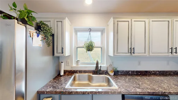 a kitchen with granite countertop a sink and a window