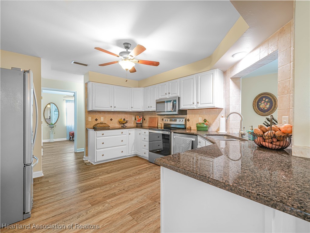 5342 Lime Road Sebring, FL 33875 - Photo 47 of 47 THROUGH THE KITCHEN DOOR, YOU ARE LEAD TO 3 GUEST BEDROOMS AND BATH. THIS IS PART OF INTELLIGENTLY DESIGNED SPLIT FLOOR PLAN. KIDS OR GUESTS BASICALLY HAVE THEIR WING OF THE HOUSE.