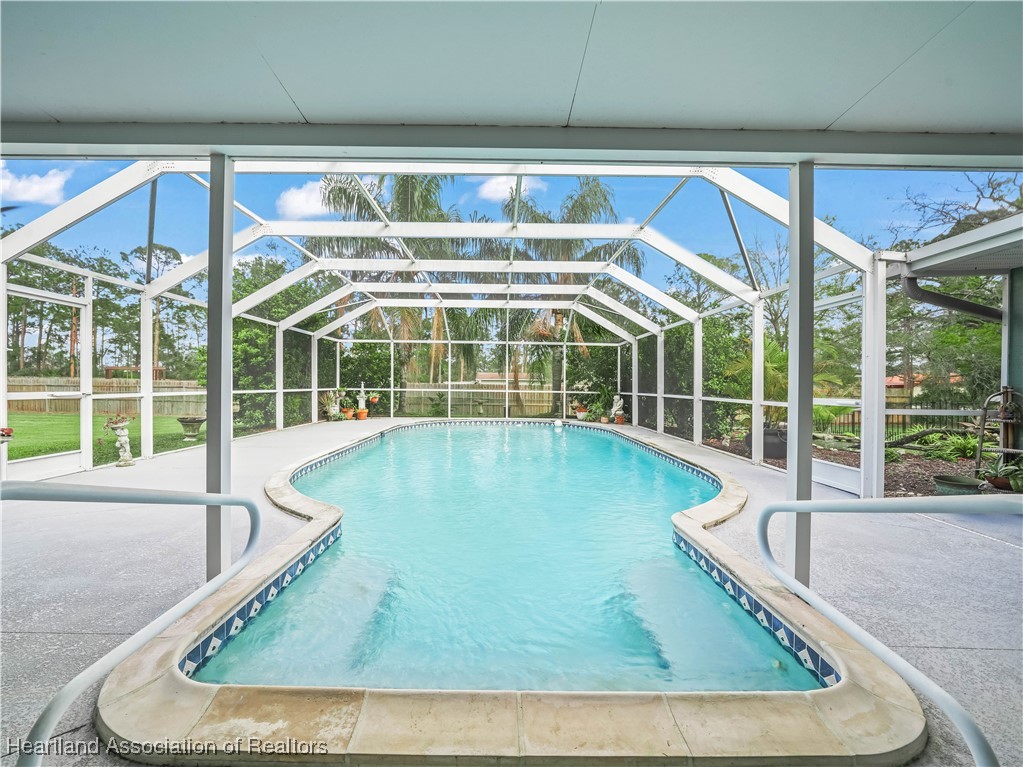 5342 Lime Road Sebring, FL 33875 - Photo 5 of 47 SPARKLING POOL WITH BUILT-IN JACUZZI AND COLOR CHANGING NIGHT LIGHTING