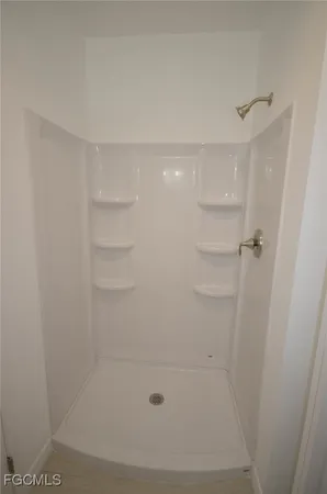 a bathroom with a granite countertop toilet sink and mirror