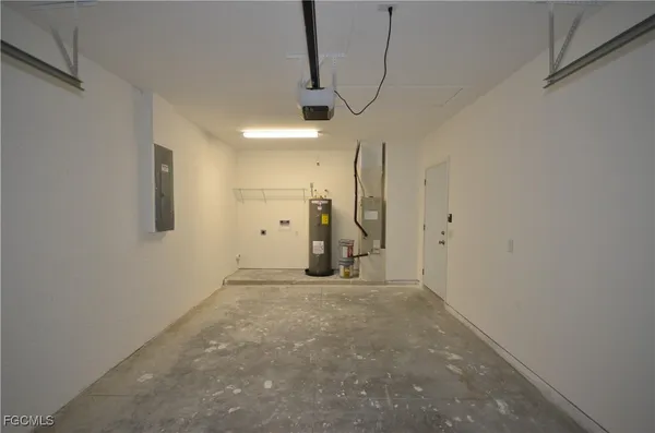 a view of an empty room with a chandelier fan