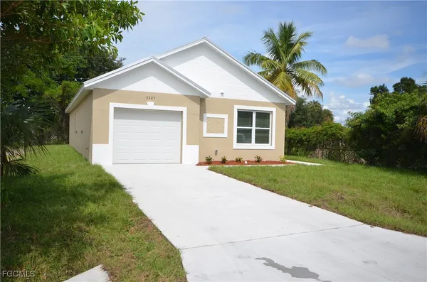 a front view of house with yard and green space