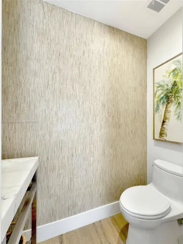 a white toilet sitting next to a shower curtain