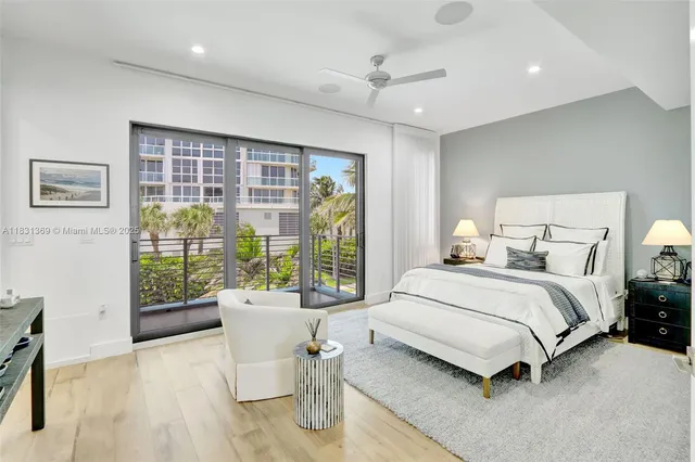 a spacious bedroom with a bed and a large window