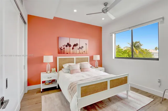 a bedroom with a bed and a painting on the wall