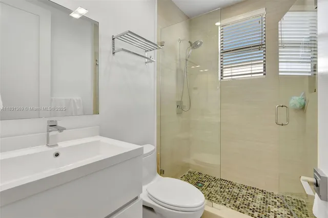 a bathroom with a sink toilet and shower