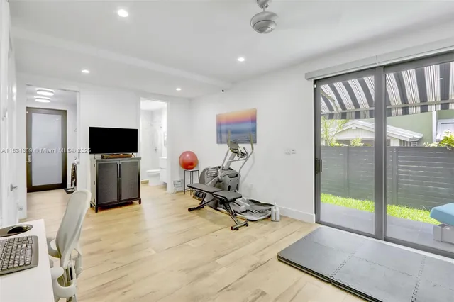 a view of a livingroom with workspace and a flat screen tv