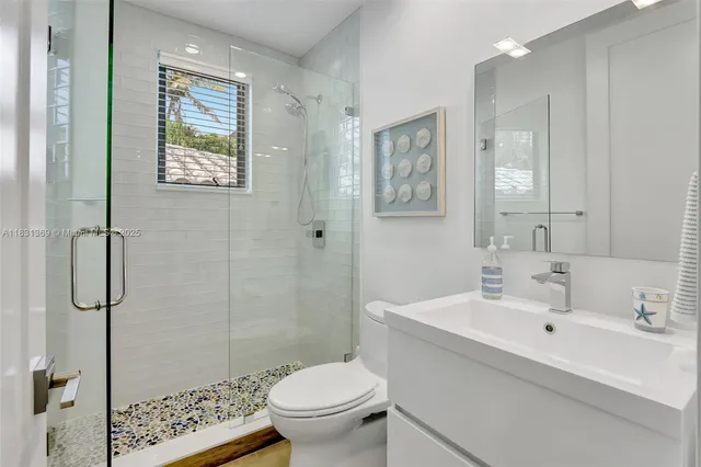 a bathroom with a sink toilet and shower