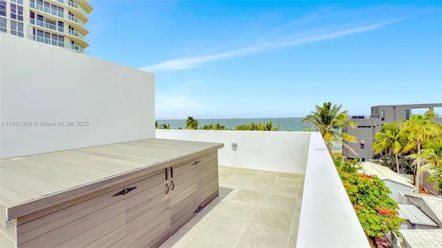 a bathroom with a tub and a potted plant