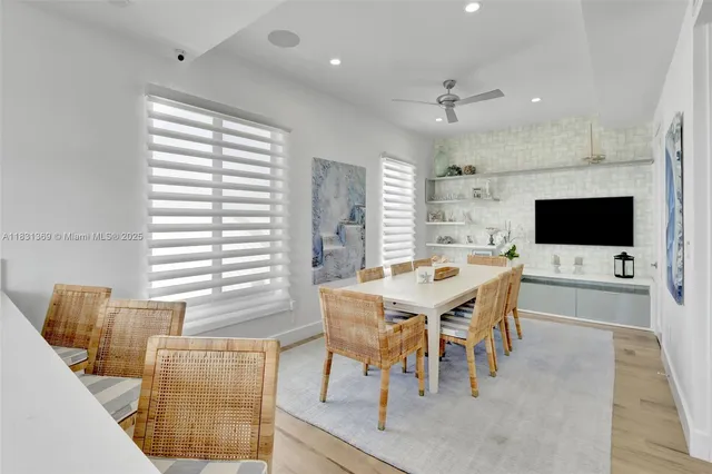 a view of a dining room with furniture and a flat screen tv