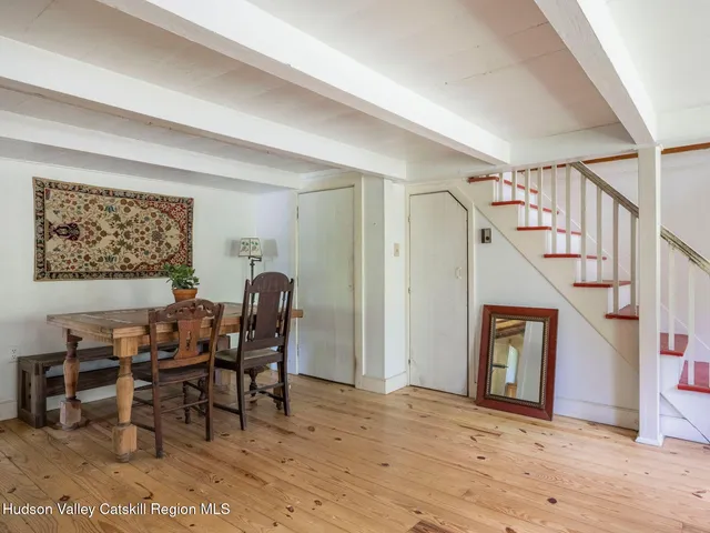 a dining room with furniture and entryway wooden floor